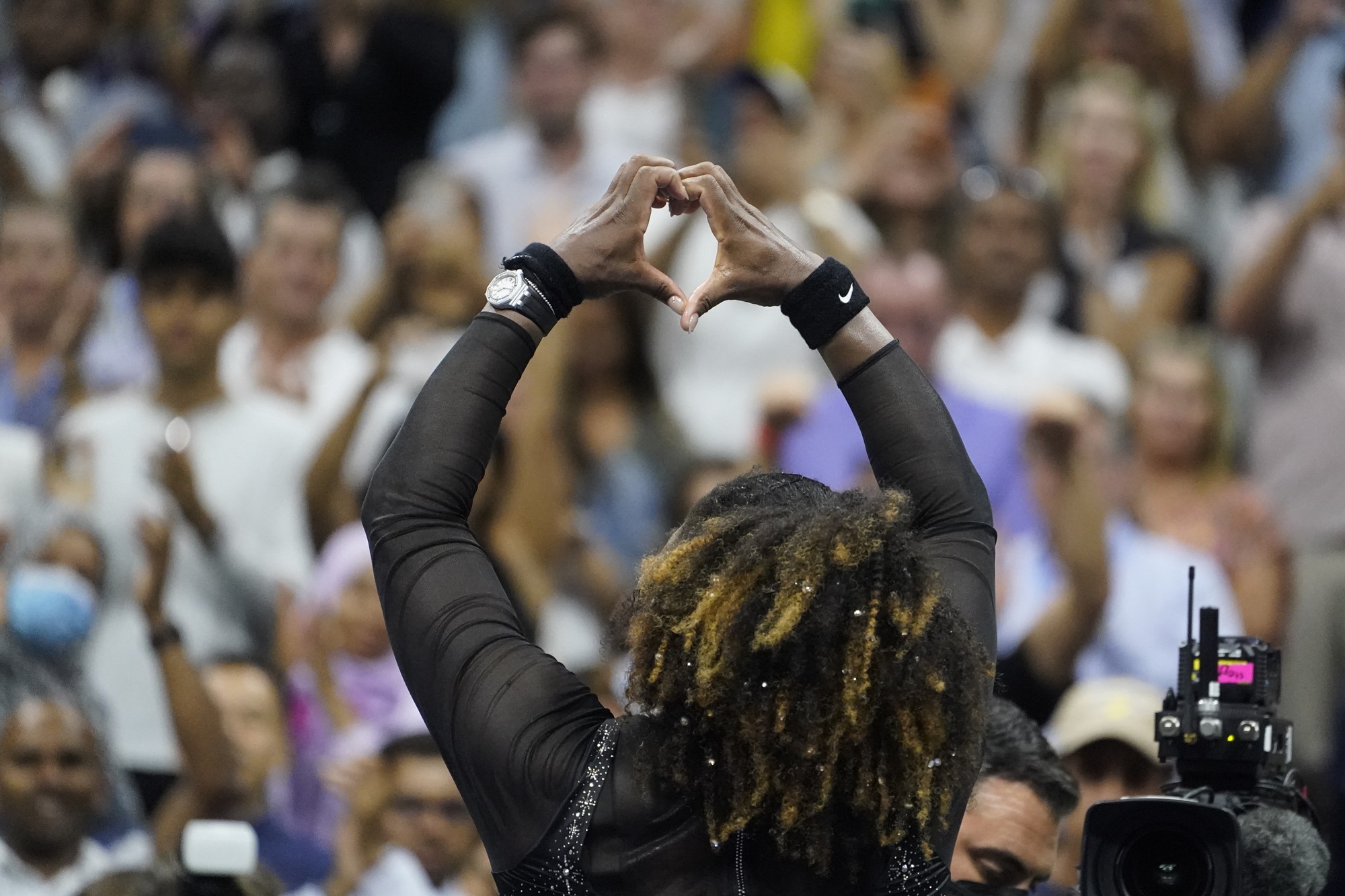Serena Williams makes a love-heart shape with her hands at the US Open.