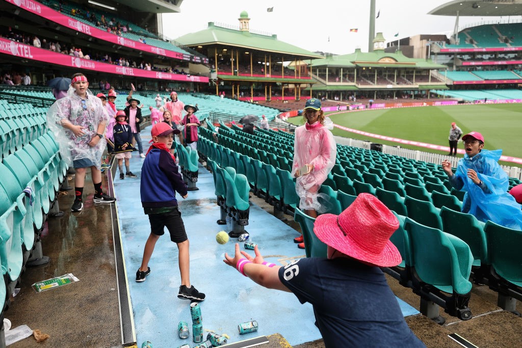 Fans play cricket in the stands at the SCG.