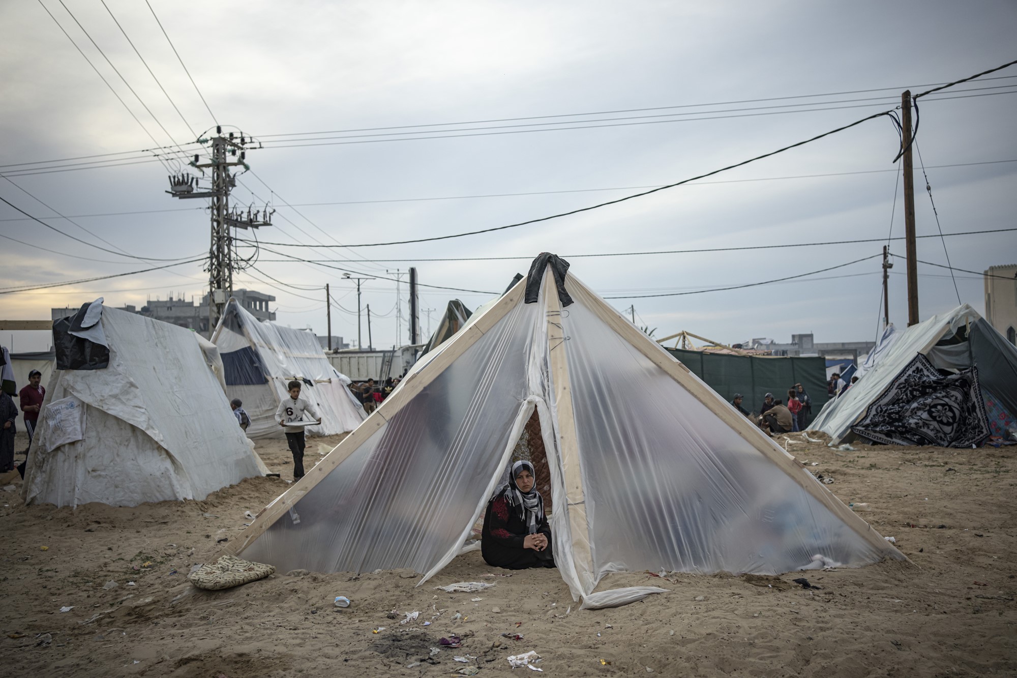 A woman inside a makeshift tent. 