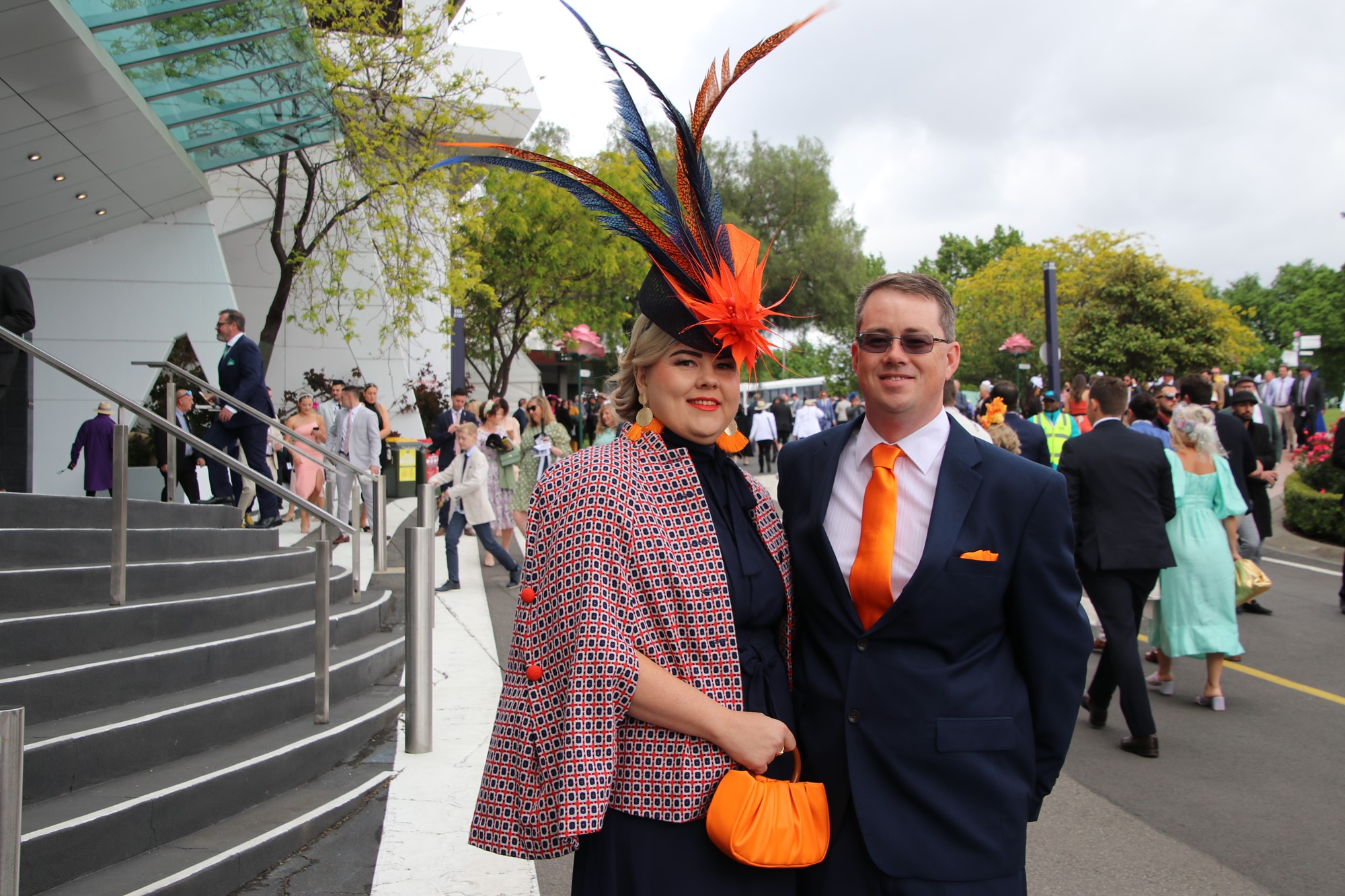 Cara and Scott stand beside each other in orange and black.