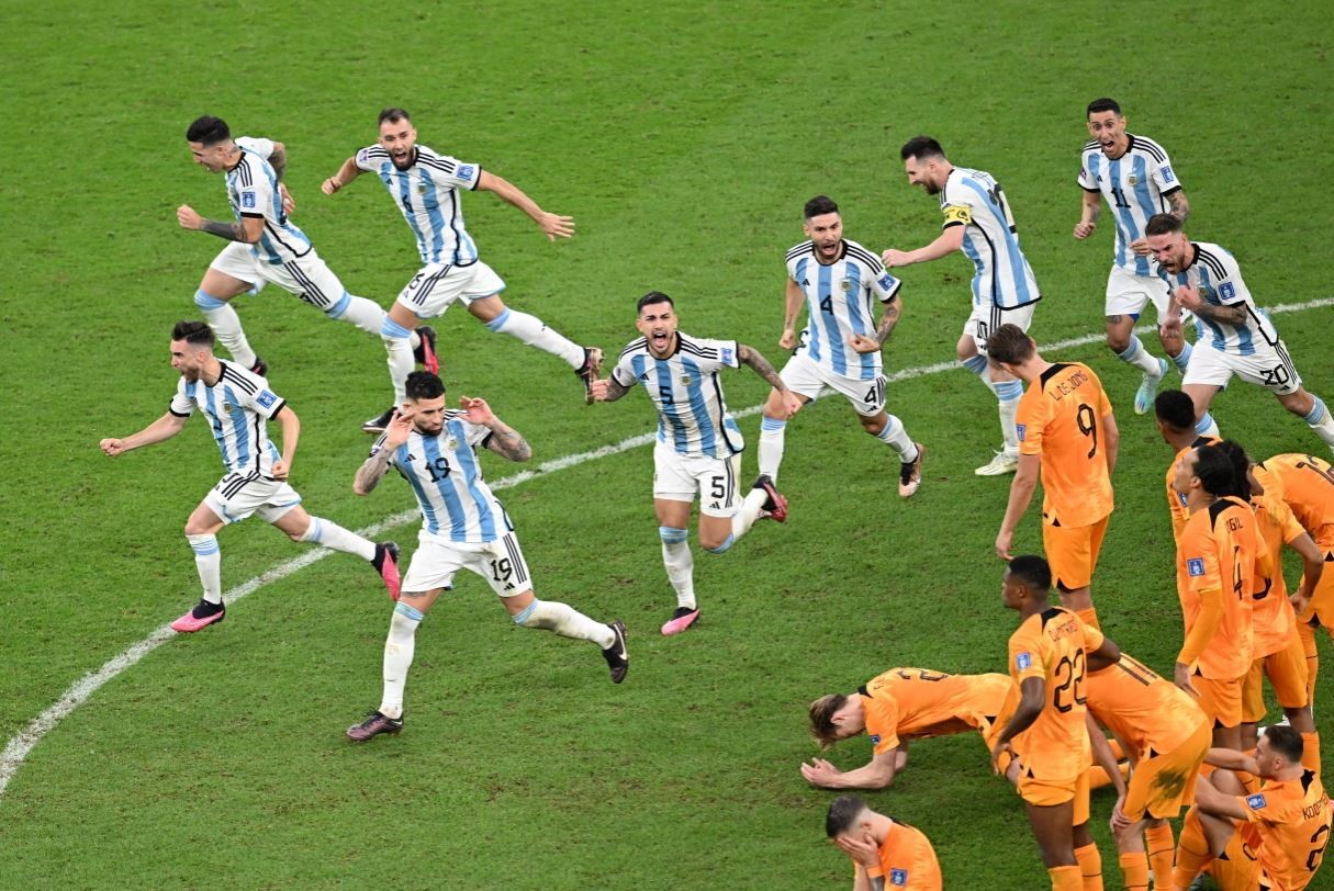 Argentina players run past and taunt Netherlands players after beating them at the FIFA World Cup,