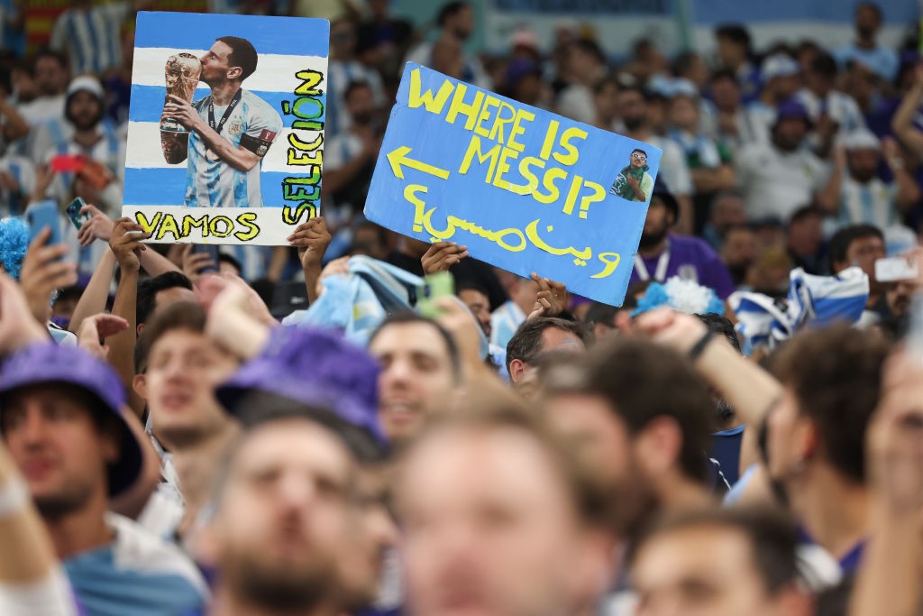 Fans hold up a sign saying "Where is Messi?" in the stands of the Argentina-Croatia FIFA World Cup semifinal