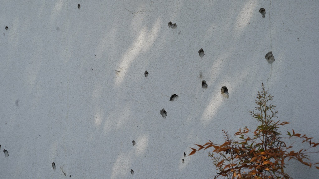 Bullet holes on a brick wall
