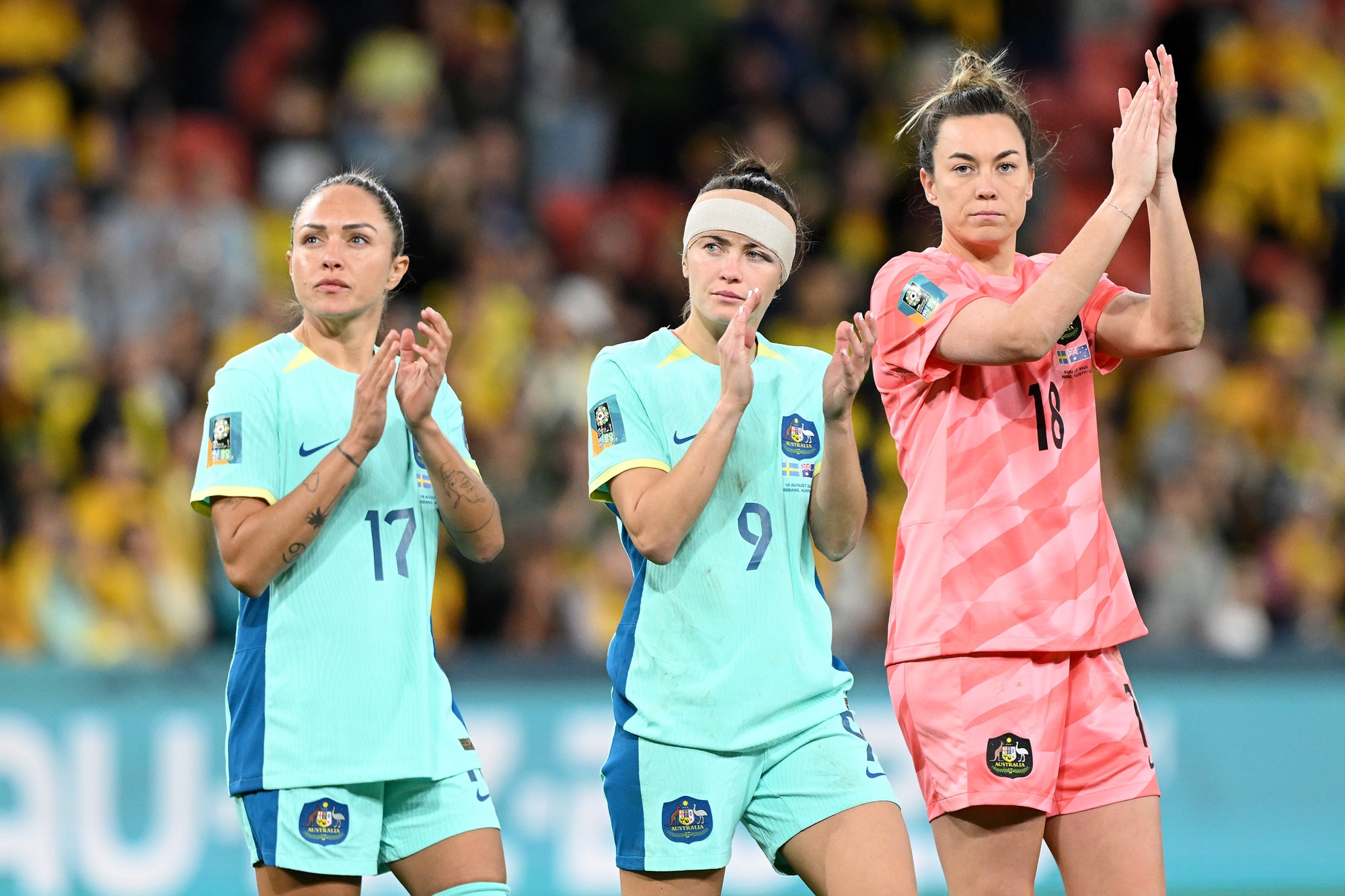 Kyah Simon, Caitlin Foord and Mackenzie Arnold applaud fans during a lap of honour at the Women's World Cup.