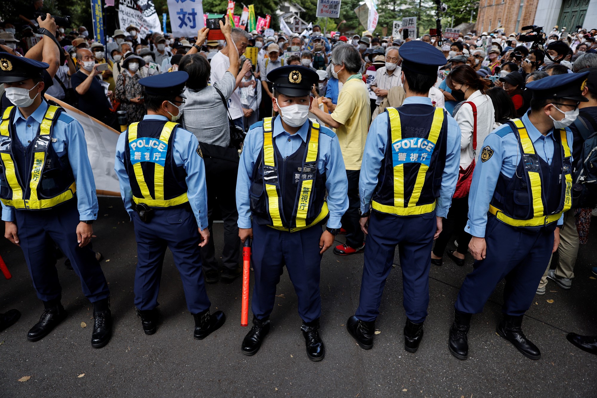 Police officers stand guard during a protest against Japan's state funeral for former Prime Minister Shinzo Abe, in Tokyo