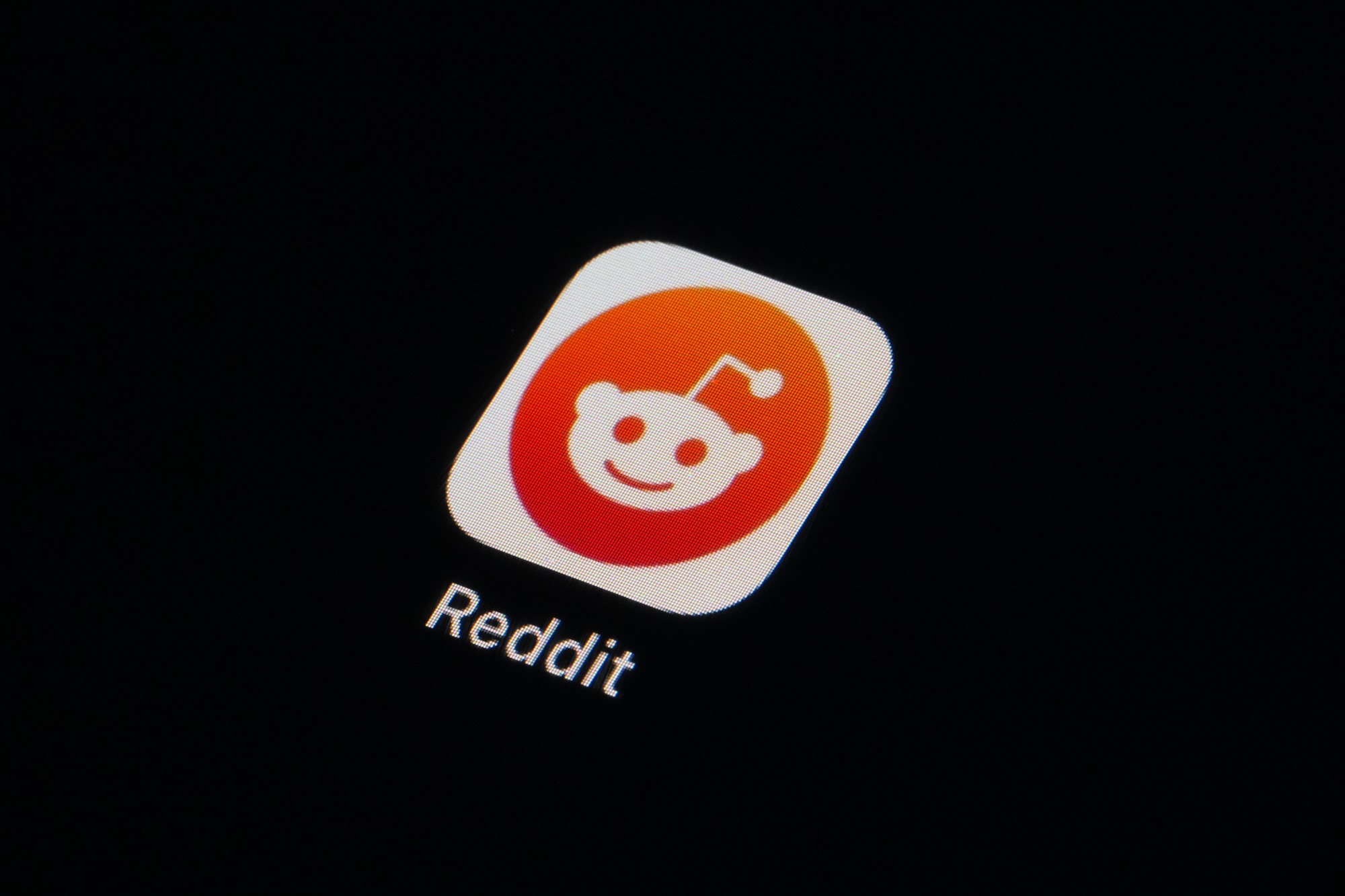 The Reddit logo on iOS, displayed on a screen