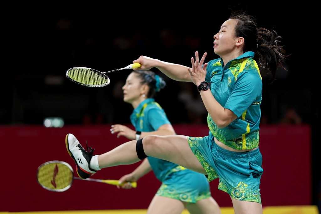 australian badminton players in action swinging racquets