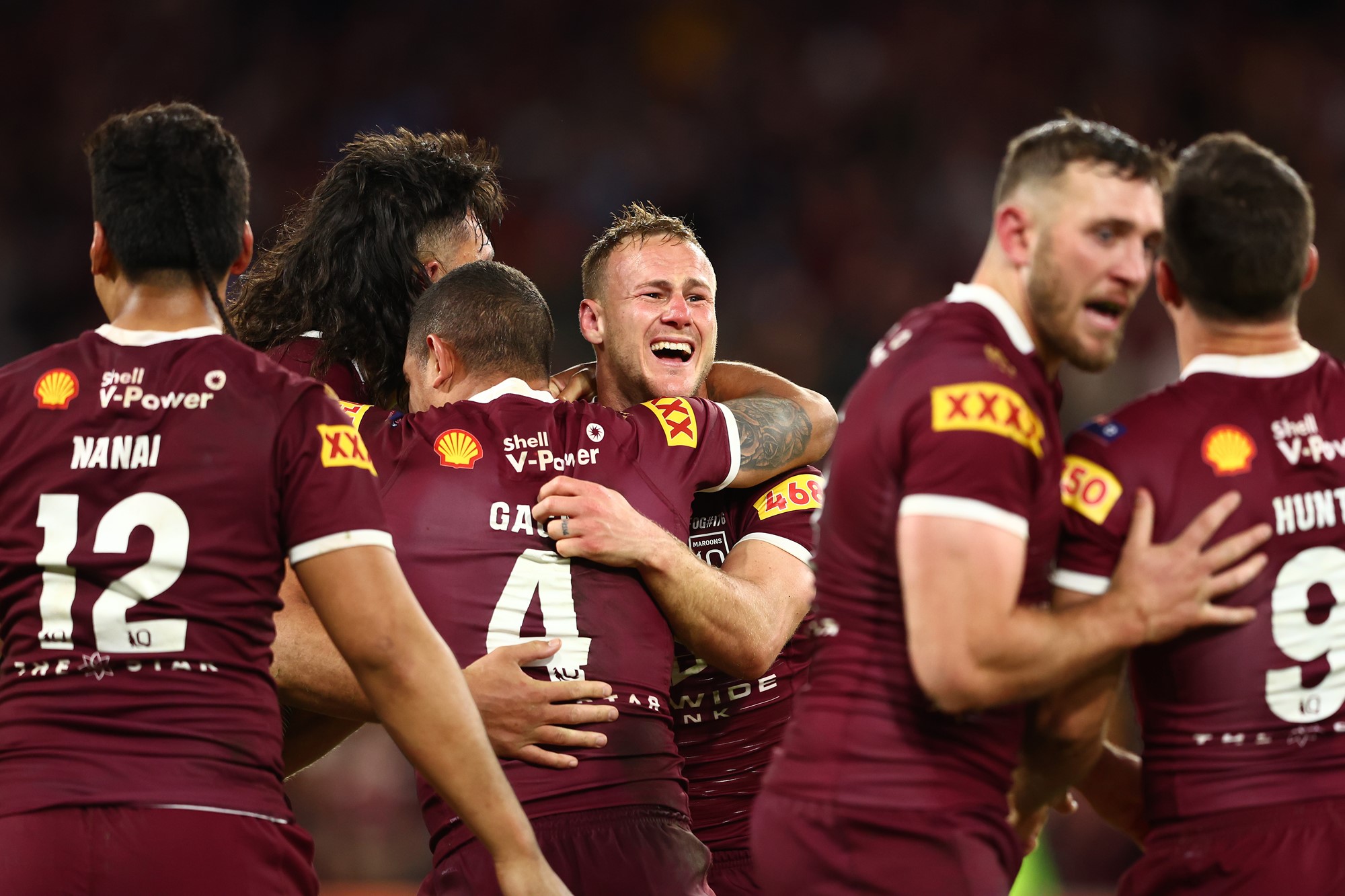 Daly Cherry-Evans is hugged by Queensland Maroons teammates after State of Origin.