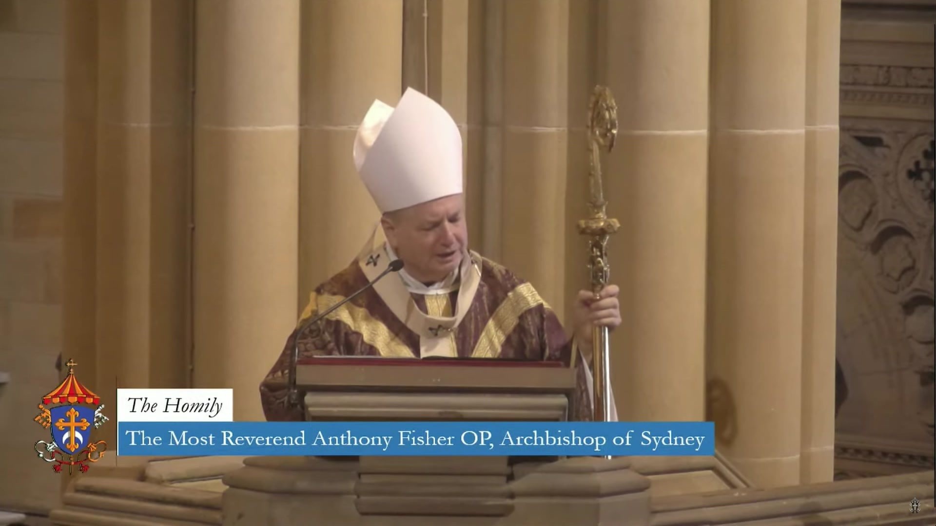 Anthony Fisher standing at a lecturn speaking